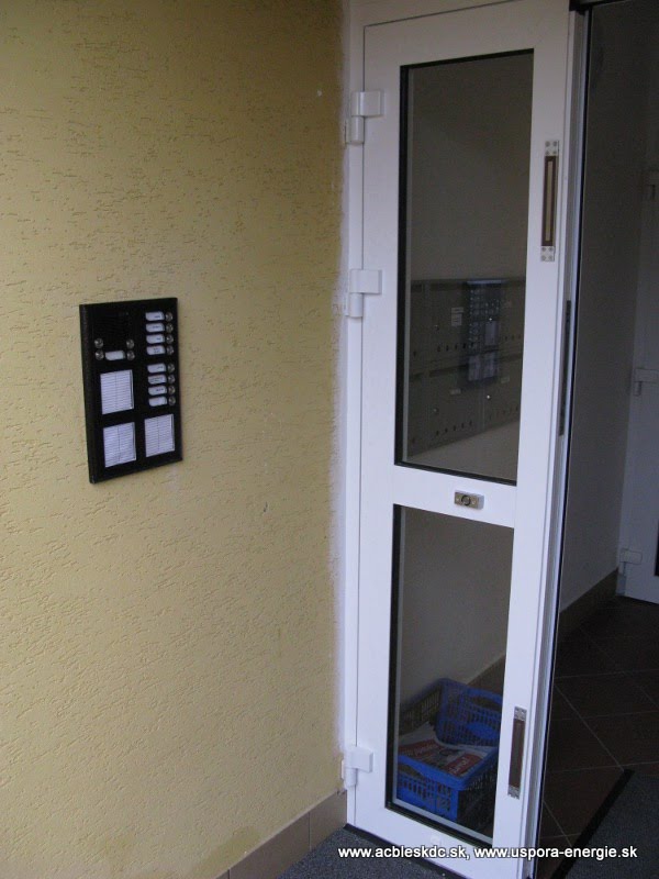 Otvorená brána - zapustené EMG zámky; nové zvončekové tablo Karát s jednostrannými menovkami a popisnými modulmi (kvôli vyplneniu miesta na fasáde po predošlom zvončekovom table)